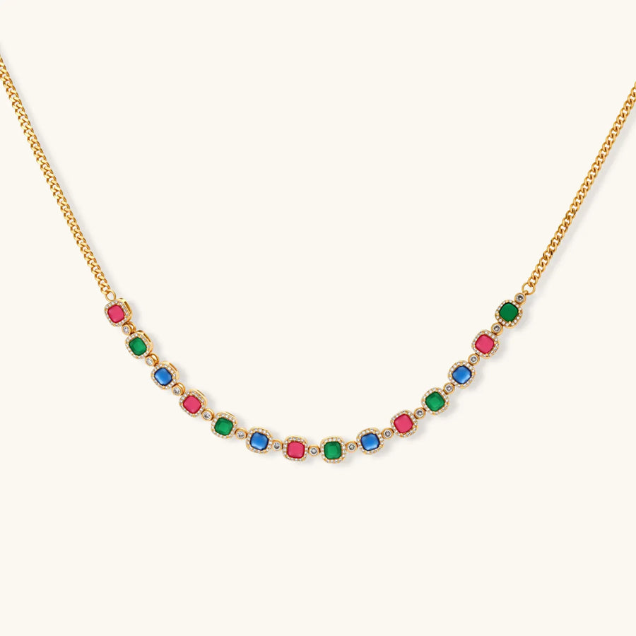 Gold-plated jewelry set with red, green, and blue cubic zirconia stones including necklace, bracelet, and drop earrings.