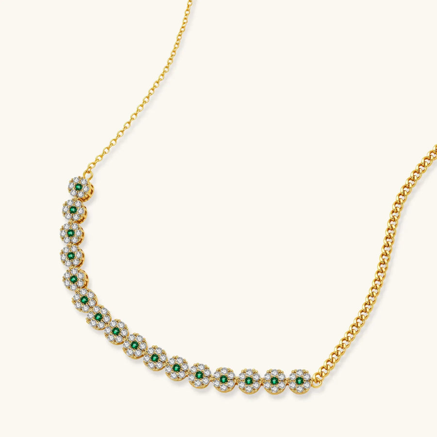 Gold-plated jewelry set with green cubic zirconia floral motifs, featuring matching necklace and pearl drop earrings
