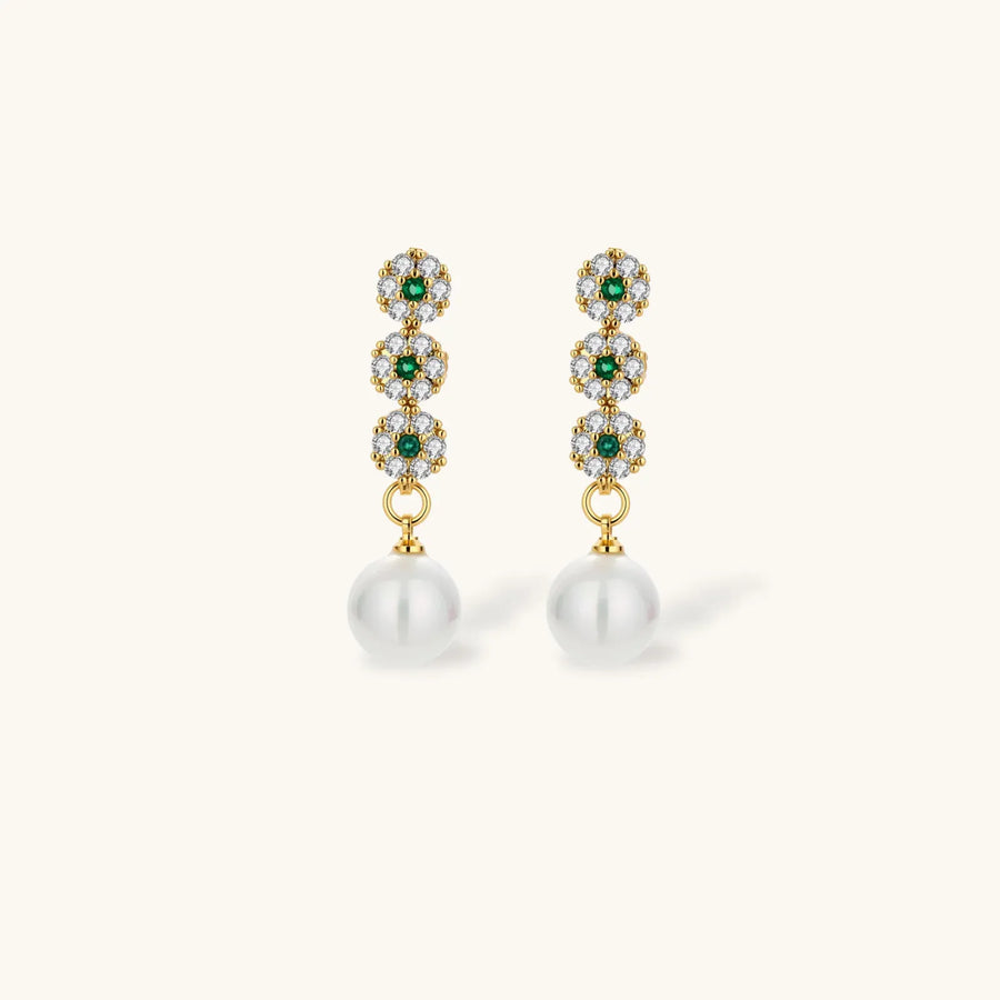 Gold-plated jewelry set with green cubic zirconia floral motifs, featuring matching necklace and pearl drop earrings