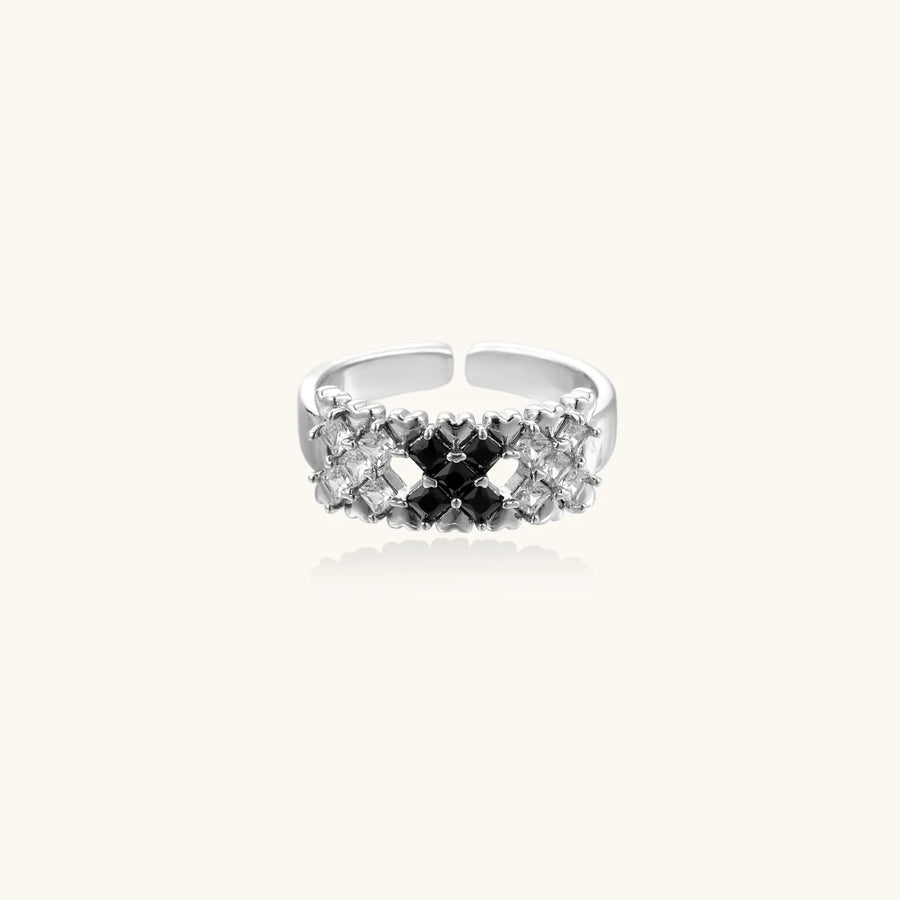 Adjustable white gold plated ring with geometric grid of black and clear zirconia stones in checkerboard pattern