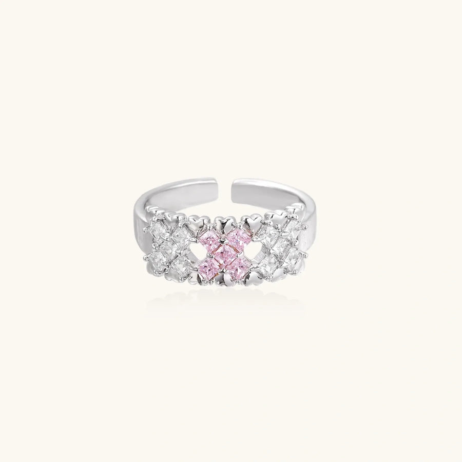 Close-up of an adjustable white gold plated ring featuring a cluster of square-cut clear and pink zirconia stones in geometric arrangement.