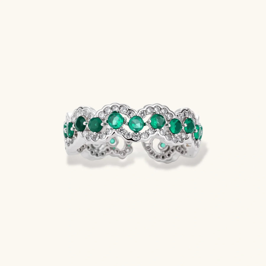 Platinum-plated copper ring with green zirconia stones in decorative scalloped wave pattern, adjustable band design.