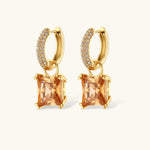 14K gold plated jewelry set featuring square champagne CZ stones with sparkling huggie earrings on cream background.