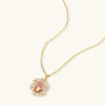 Ornate gold-plated jewelry set featuring peach center stone surrounded by clear AAA cubic zirconia crystals