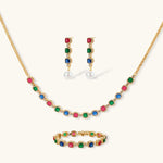 Gold-plated jewelry set with red, green, and blue cubic zirconia stones including necklace, bracelet, and drop earrings.