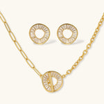Gold-plated necklace and earring set with circular CZ crystal pendants featuring radial design on cream background