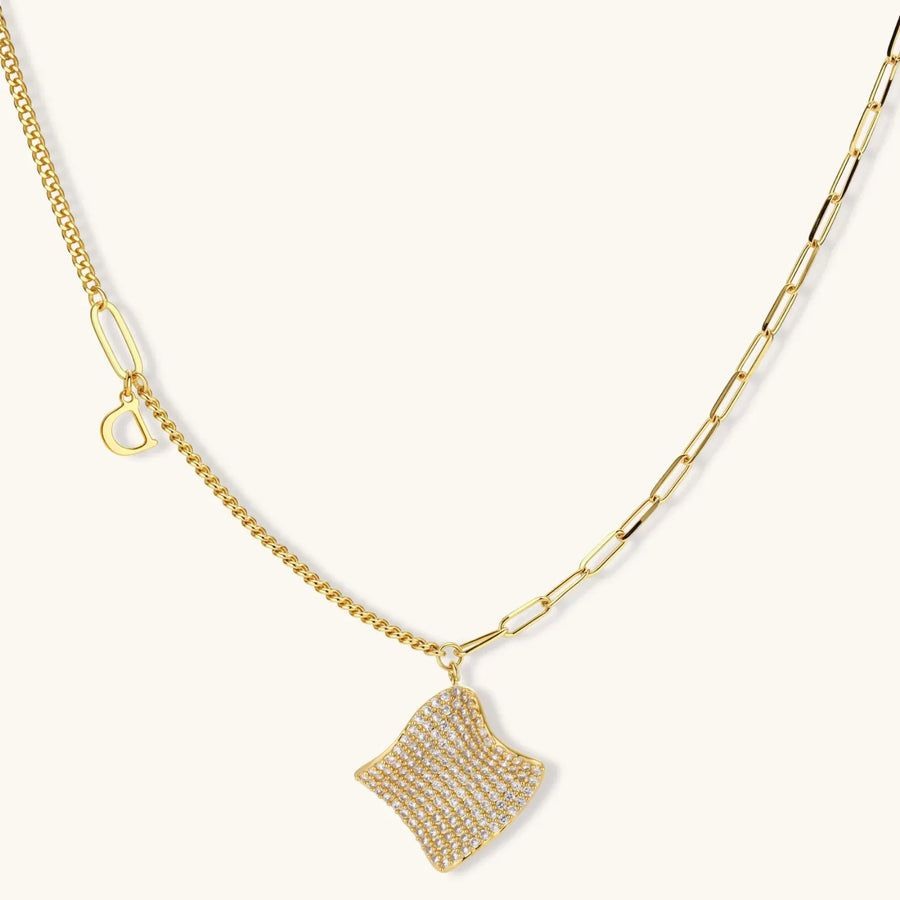 Gold-plated wavy jewelry set with crystal detailing featuring necklace with dual chains and matching textured earrings