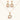 14K gold plated jewelry set with pink and green cubic zirconia flowers arranged in wreath design on cream background