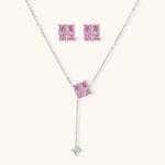 White gold plated jewelry set with pink cubic zirconia stones in geometric cross design, featuring Y-necklace and square stud earrings