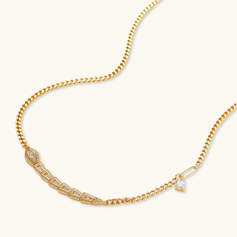 Gold-plated necklace with geometric diamond segments and matching huggie earrings featuring cubic zirconia details