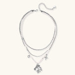 Multi-strand layered necklace set with silver chains, white pearls, star charm, heart pendant, and ornate decorative piece