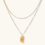 Layered paperclip chain necklace with organic flowing pendant made from eco-zinc alloy in warm gold finish