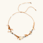 Adjustable brown cord necklace with citrine, coffee calcite beads and striped accents on white background.