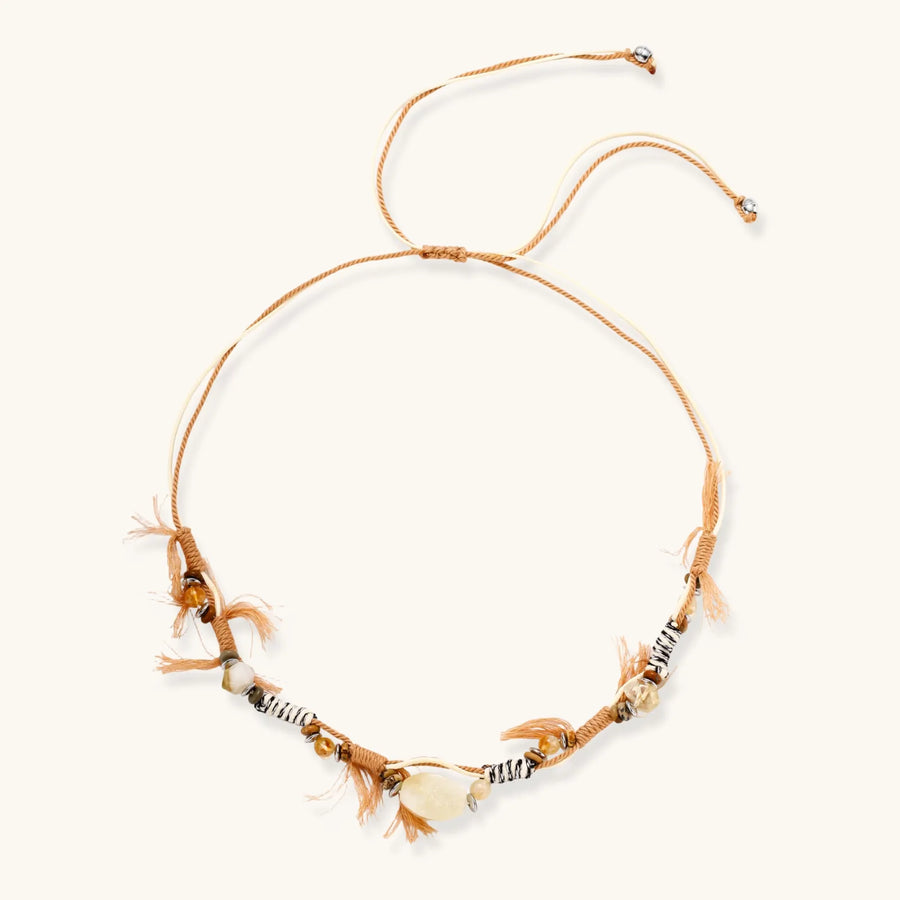 Adjustable brown cord necklace with citrine, coffee calcite beads and striped accents on white background.