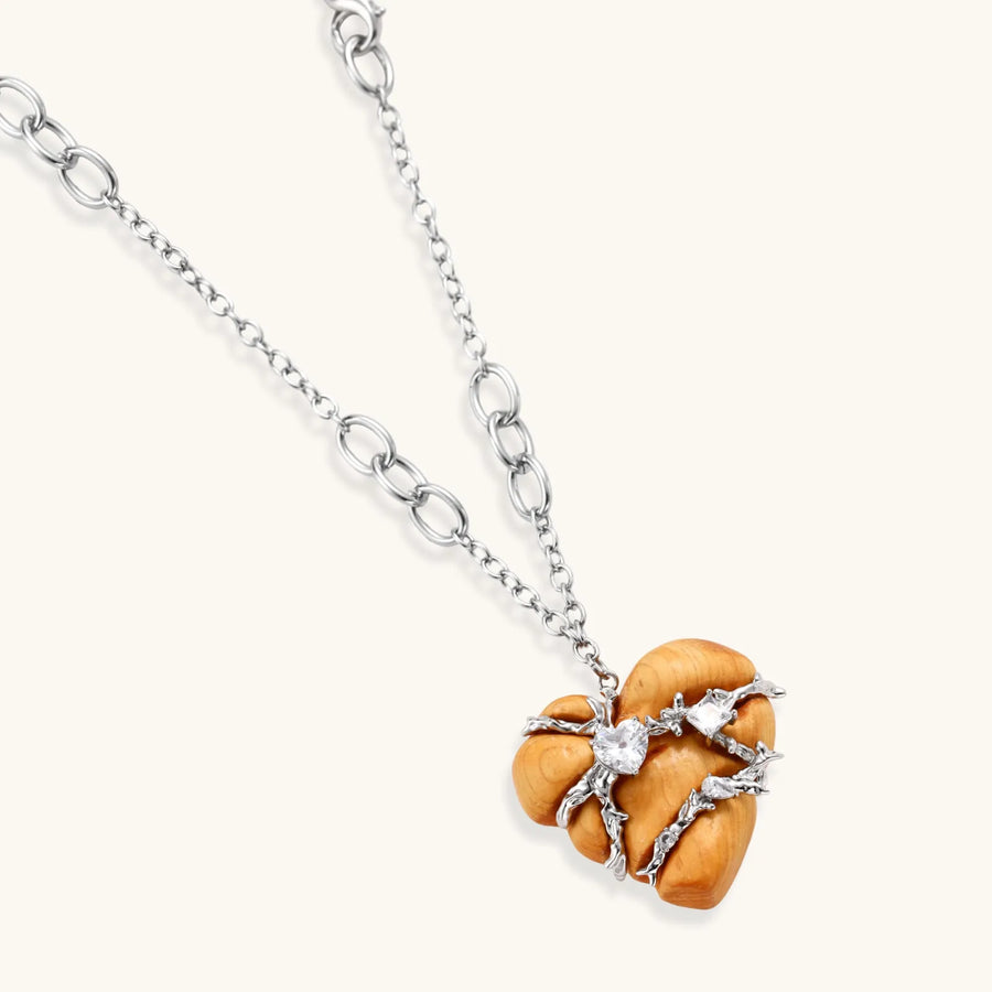 Adjustable brass chain necklace with natural wood heart pendant featuring wire wrapping and zirconia crystal accents