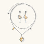 Delicate eco-brass jewelry set featuring gold star and silver moon crescents with clear zirconia crystal drops on cream background