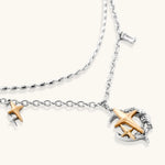 Delicate eco-brass jewelry set featuring gold star and silver moon crescents with clear zirconia crystal drops on cream background