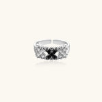 Adjustable white gold plated ring with geometric grid of black and clear zirconia stones in checkerboard pattern