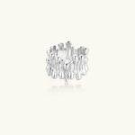 Wide band ring with sculptural wave ripples in polished white gold plated eco-brass on cream background