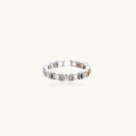 White gold plated ring with architectural lattice design and zirconia accents on cream background