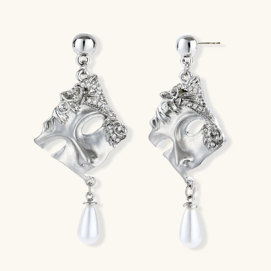 Ornate silver-toned masquerade mask jewelry set featuring rhinestone details and pearl drop earrings on white background.