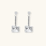 Geometric jewelry set with textured cube pendants on chains, featuring eco-zinc alloy in silver and gold finishes.
