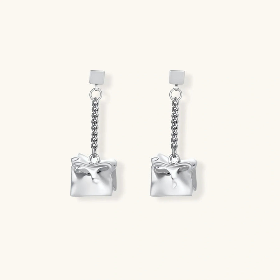 Geometric jewelry set with textured cube pendants on chains, featuring eco-zinc alloy in silver and gold finishes.