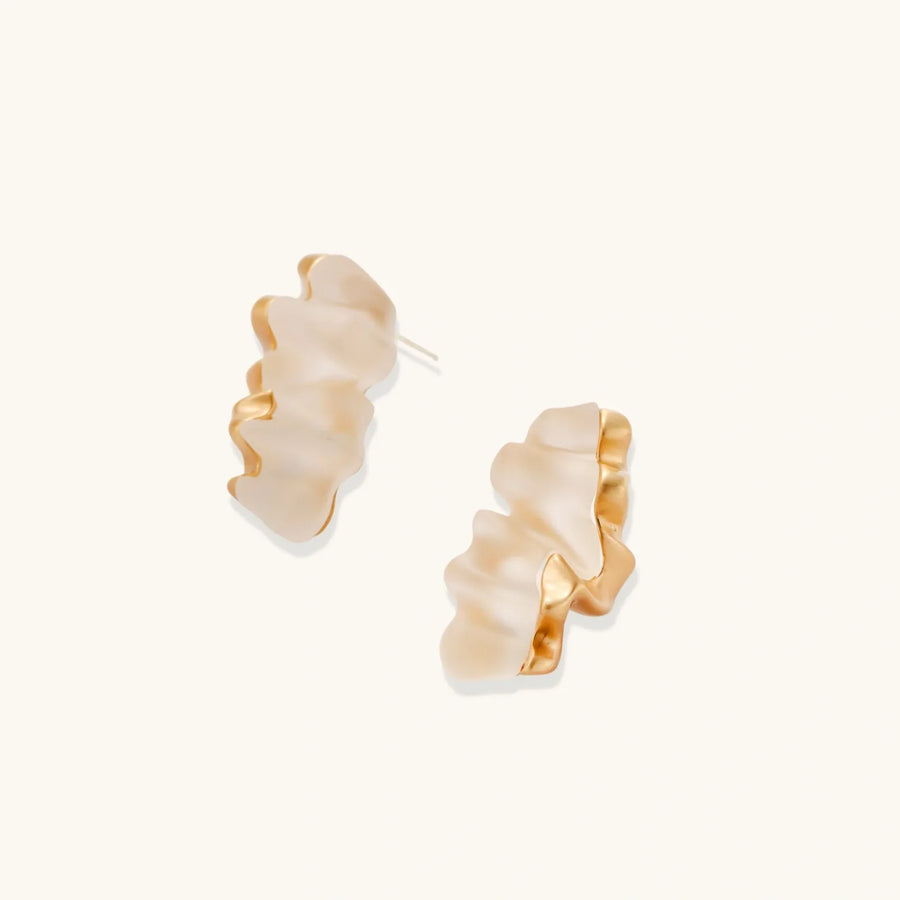 Sculptural gold-toned jewelry set featuring wavy organic earrings and matching necklace pendant with translucent resin accents.