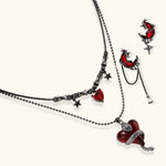 Gothic jewelry set with asymmetrical black metal earrings featuring red crescent moons, stars, and layered necklaces with heart pendants