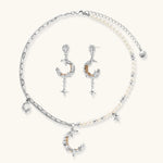 Mixed-metal jewelry set featuring layered necklaces with crescent moon pendant and pearl beads, plus matching star-drop earrings.