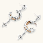 Mixed-metal jewelry set featuring layered necklaces with crescent moon pendant and pearl beads, plus matching star-drop earrings.