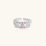 Close-up of an adjustable white gold plated ring featuring a cluster of square-cut clear and pink zirconia stones in geometric arrangement.