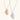 Modern sculptural pendant necklace with twisted metallic design on delicate silver chain against neutral background.