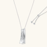 Modern silver necklace with vertical ridged pendant and adjustable chain on white background, eco-friendly zinc alloy construction.