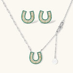 Geometric horseshoe-shaped jewelry set with radiating white zirconia center and jade-green border stones on white background.