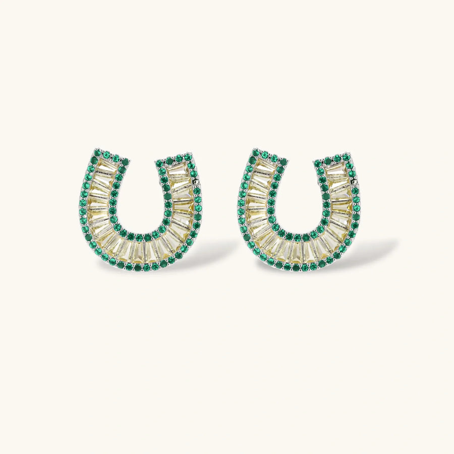 Geometric horseshoe-shaped jewelry set with radiating white zirconia center and jade-green border stones on white background.