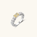 Adjustable ring with emerald-cut yellow zirconia center and clear accent stones in geometric platinum-plated setting