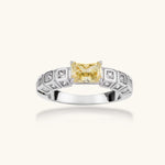 Adjustable ring with emerald-cut yellow zirconia center and clear accent stones in geometric platinum-plated setting