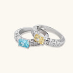 Adjustable ring with emerald-cut yellow zirconia center and clear accent stones in geometric platinum-plated setting