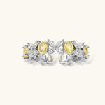 Close-up of platinum-plated copper eternity ring featuring alternating yellow and clear marquise-cut stones in elegant band setting.