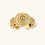 Ornate gold-plated ring with detailed engravings and central zirconia stone on adjustable band