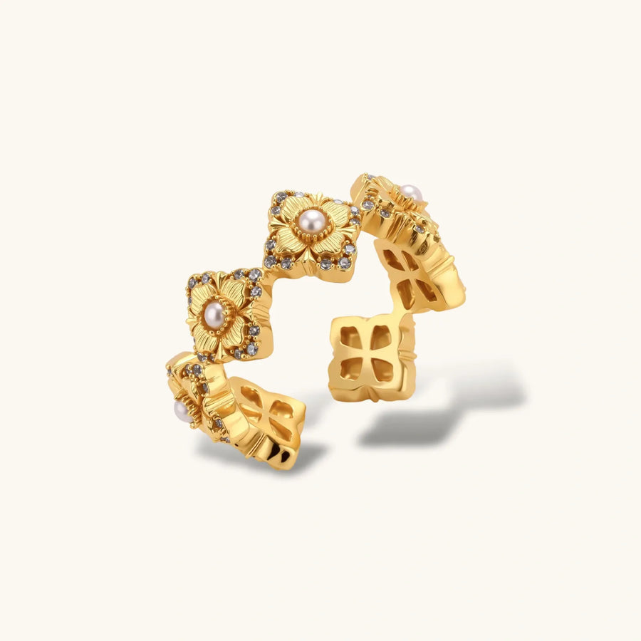 Gold-plated adjustable ring with multiple flower motifs, each featuring a central pearl and cubic zirconia stones