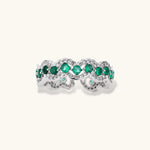 Platinum-plated copper ring with green zirconia stones in decorative scalloped wave pattern, adjustable band design.