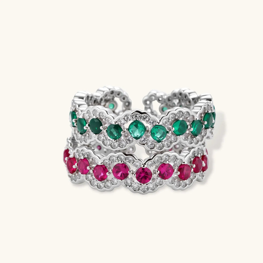 Platinum-plated copper ring with green zirconia stones in decorative scalloped wave pattern, adjustable band design.