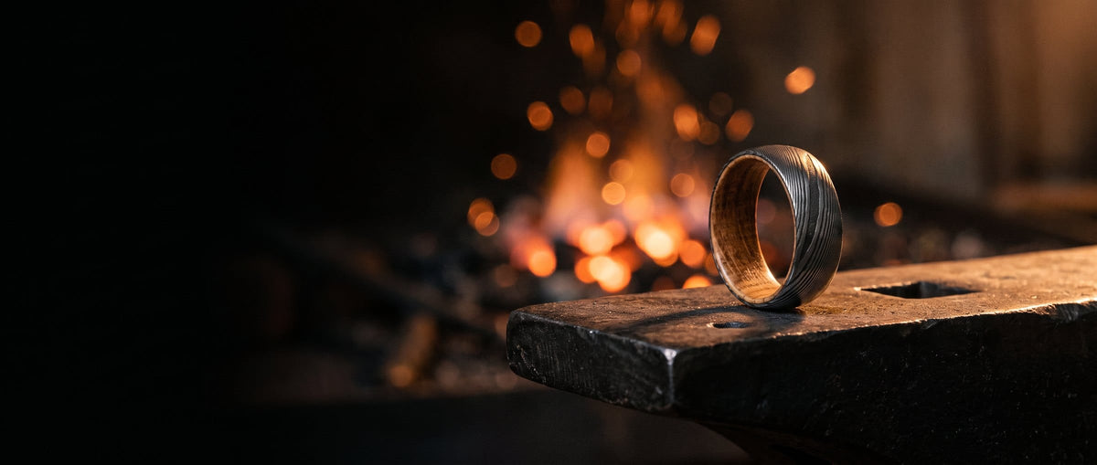 Damascus steel ring on a blacksmith anvil by the forge